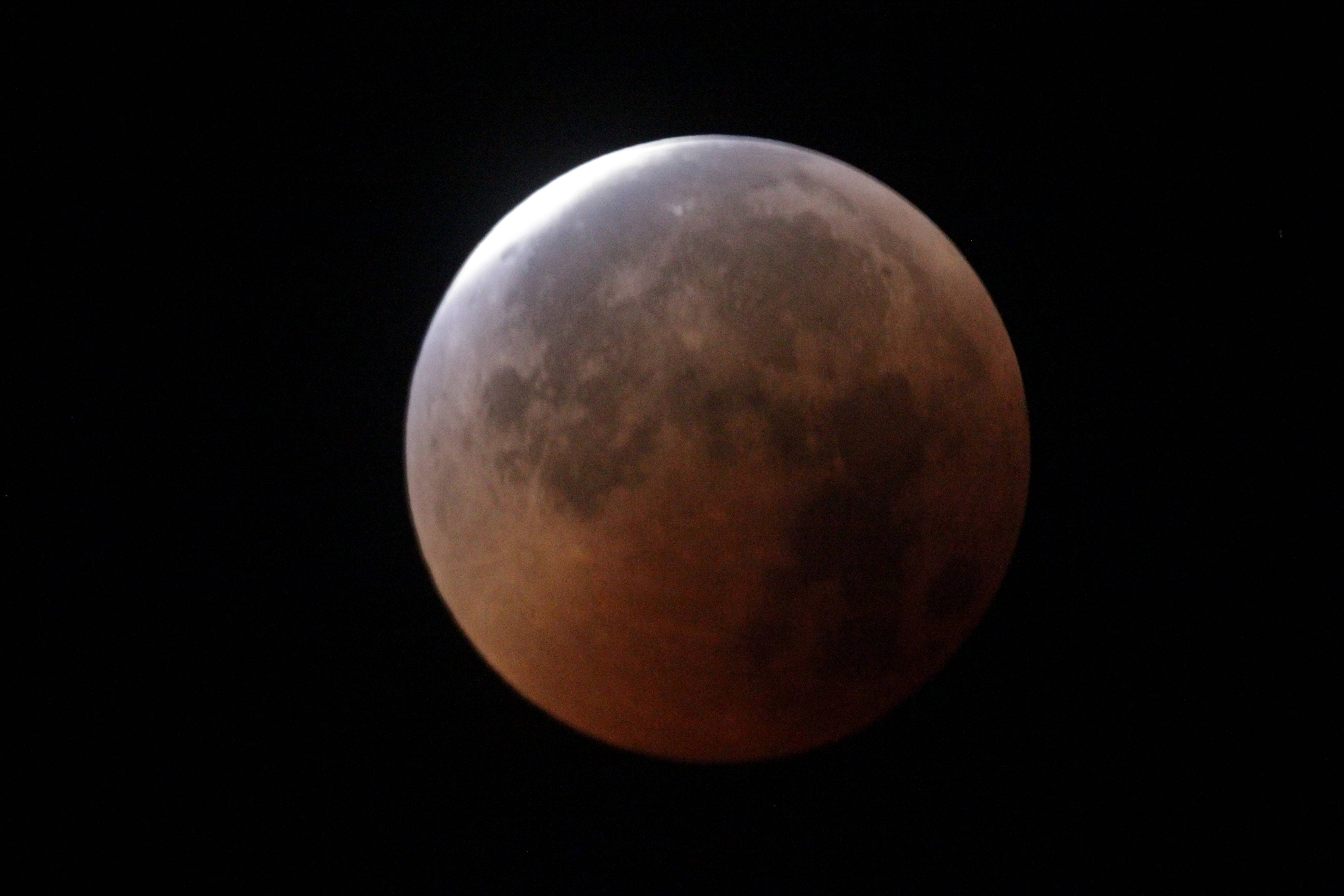 Phases of a lunar eclipse showing the moon turning red.