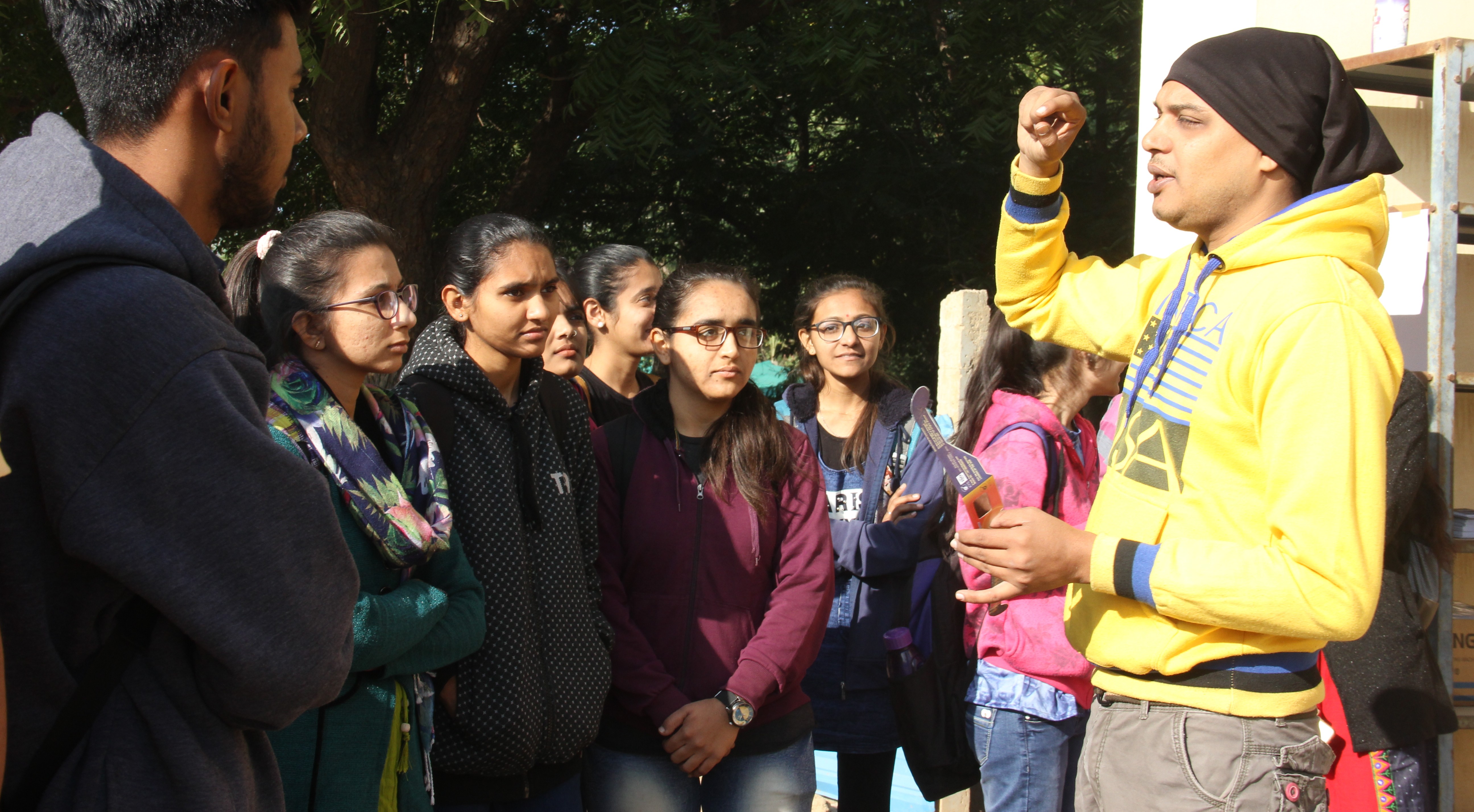 A public astronomy workshop with multiple telescopes set up.